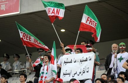 Iranian football supporters wave their national flag against the disputed election win of President Mahmoud Ahmadinejad during the 2010 World Cup Asian qualifer match.